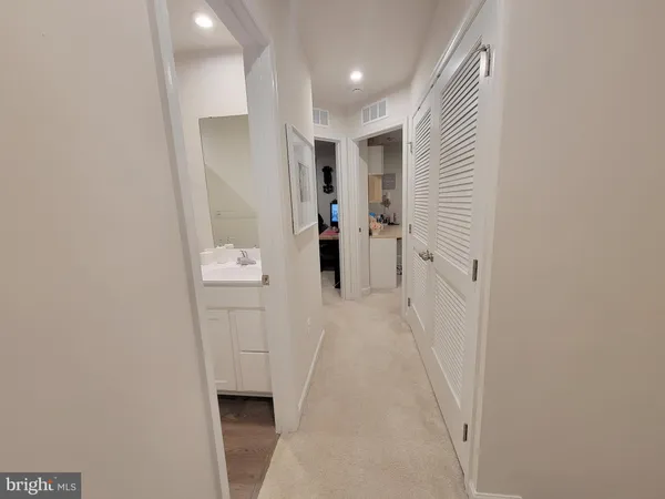 a hallway with white cabinets