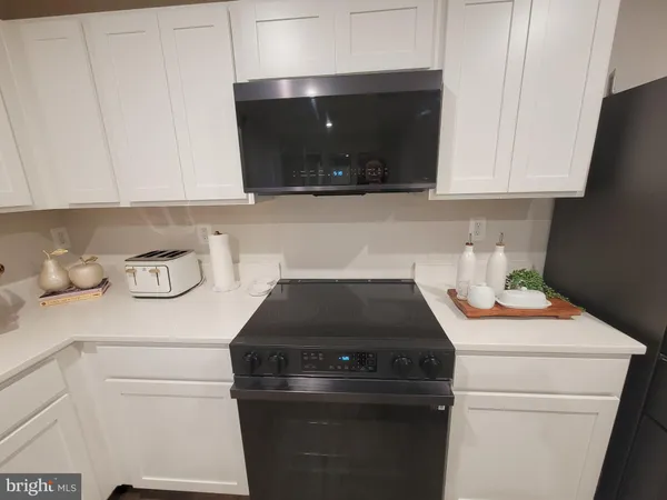 a kitchen with a stove and cabinets
