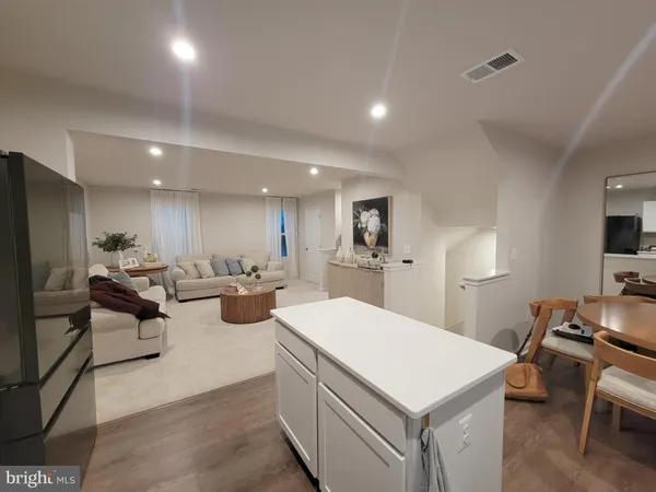 a kitchen with a stove a refrigerator and a dining table