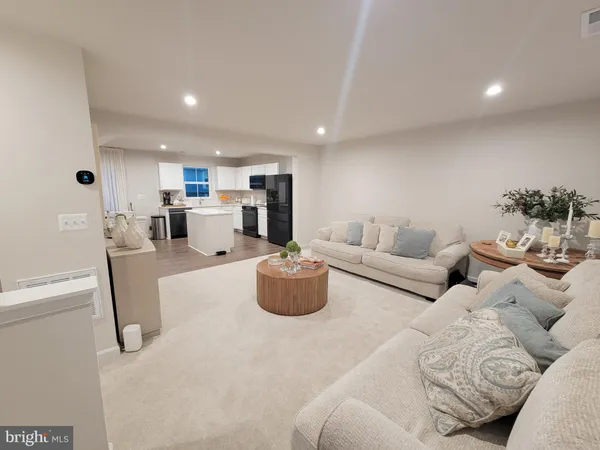 a living room with furniture kitchen and a couch