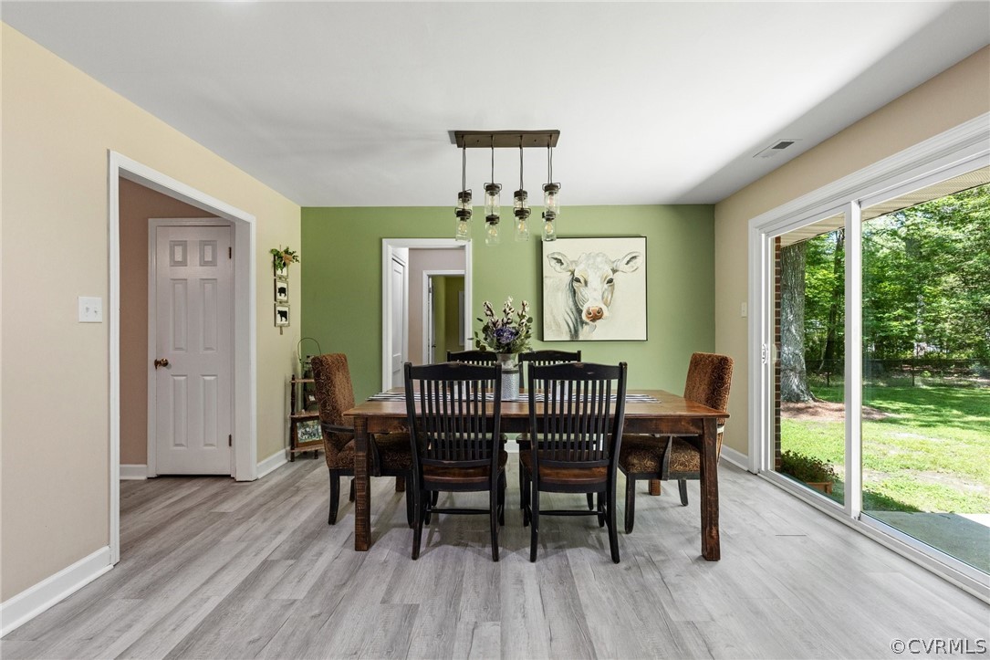 6286 McClellan Road Mechanicsville, VA 23111 - Photo 11 of 29 a view of a dining room with furniture window and wooden floor