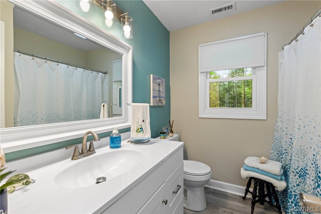 6286 McClellan Road Mechanicsville, VA 23111 - Photo 17 of 29 a bathroom with a sink a toilet and a mirror
