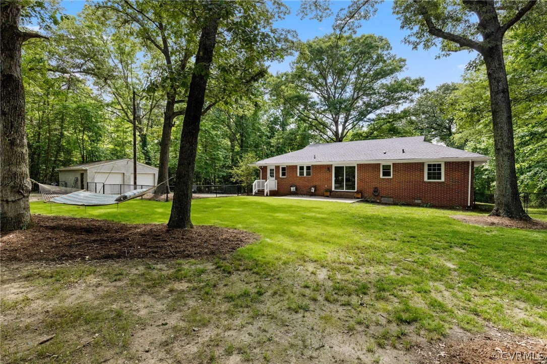 6286 McClellan Road Mechanicsville, VA 23111 - Photo 28 of 29 a view of house with a garden and trees