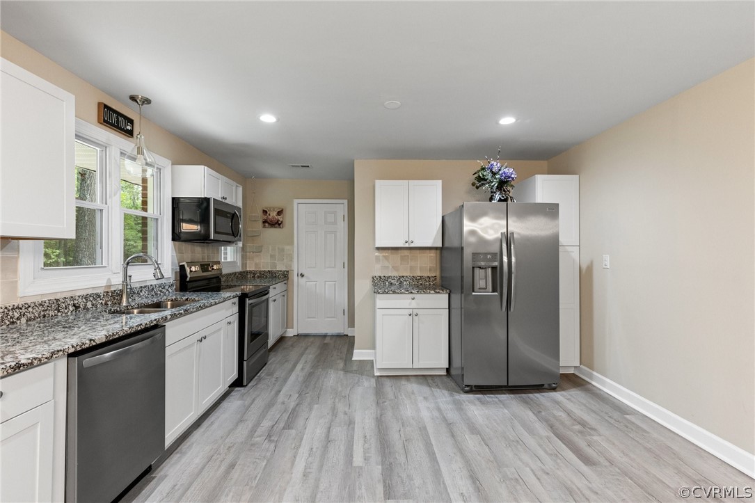 6286 McClellan Road Mechanicsville, VA 23111 - Photo 8 of 29 a large kitchen with a center island wooden floor stainless steel appliances and cabinets