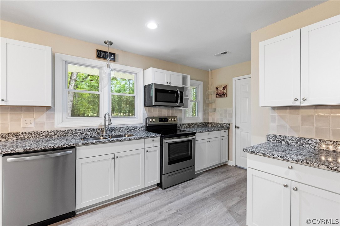 6286 McClellan Road Mechanicsville, VA 23111 - Photo 9 of 29 a kitchen with granite countertop a stove top oven sink and cabinets