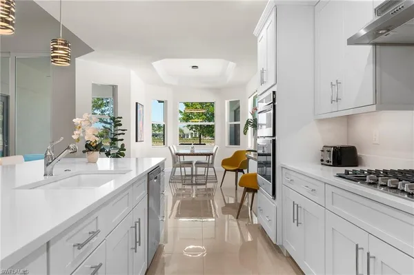 a kitchen with a sink appliances and cabinets
