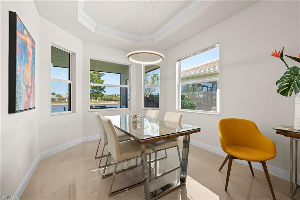 8897 Redonda Drive Naples, FL 34114 - Photo 15 of 42 Dining room with crown molding and a tray ceiling
