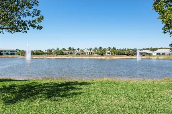 a view of a lake with houses in the back