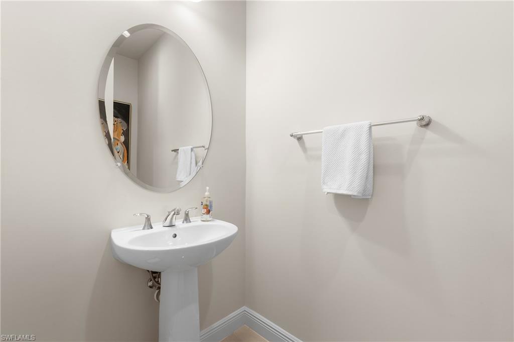 8897 Redonda Drive Naples, FL 34114 - Photo 26 of 42 Half bathroom with baseboards
