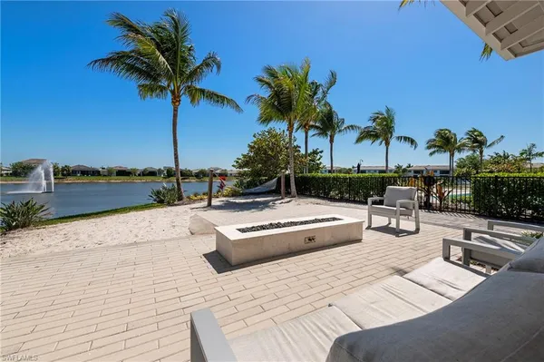 a view of swimming pool with outdoor seating and plants