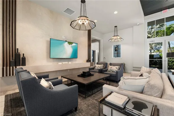 a living room with furniture and a chandelier