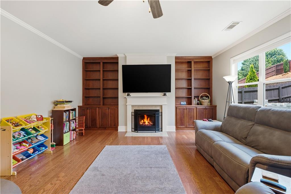 5825 Willow Oak Pass Cumming, GA 30040 - Photo 20 of 55 a living room with furniture fireplace and flat screen tv