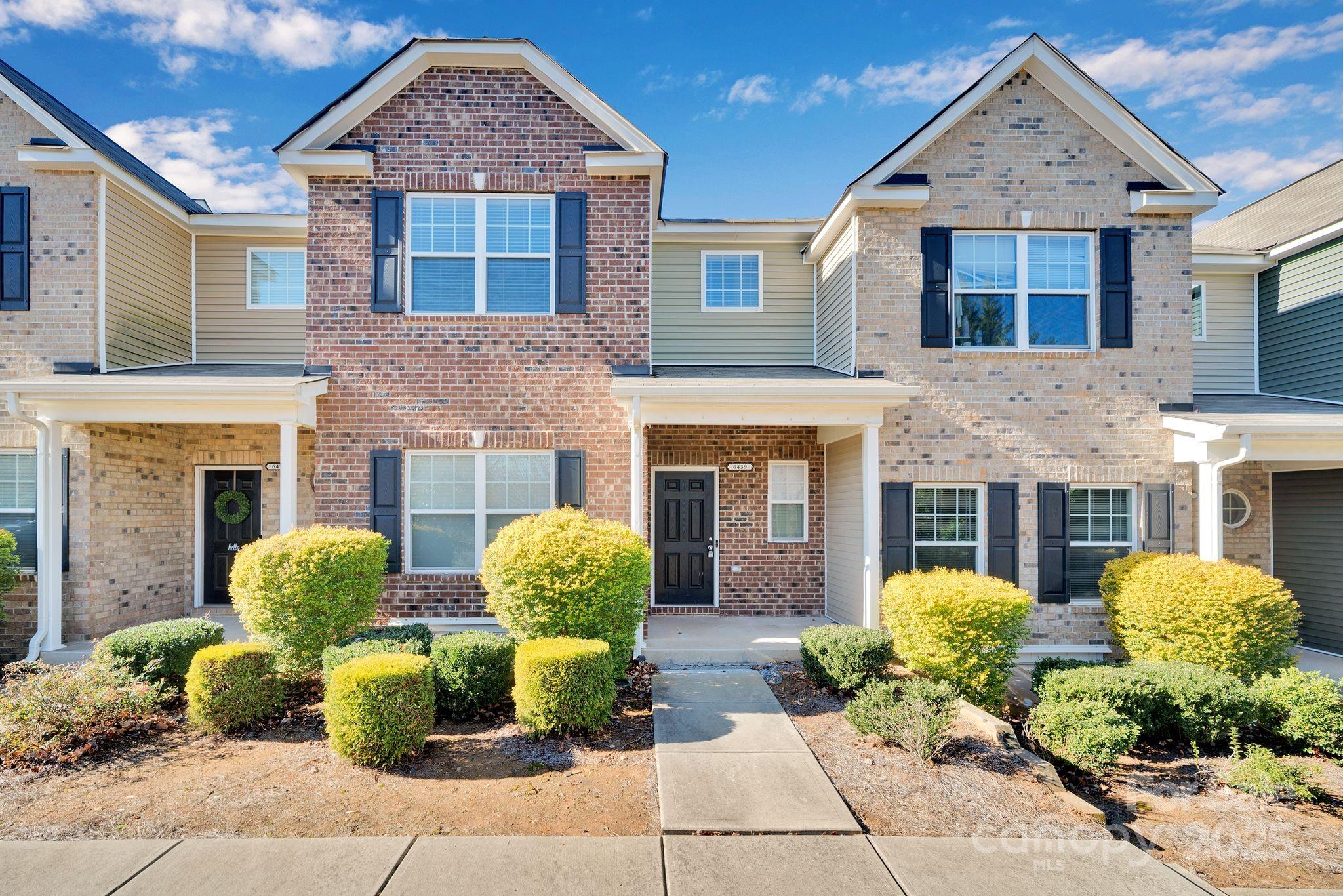 6439 Prosperity Church Road Charlotte, NC 28269 - Photo 1 of 46 a front view of a house with garden and plants