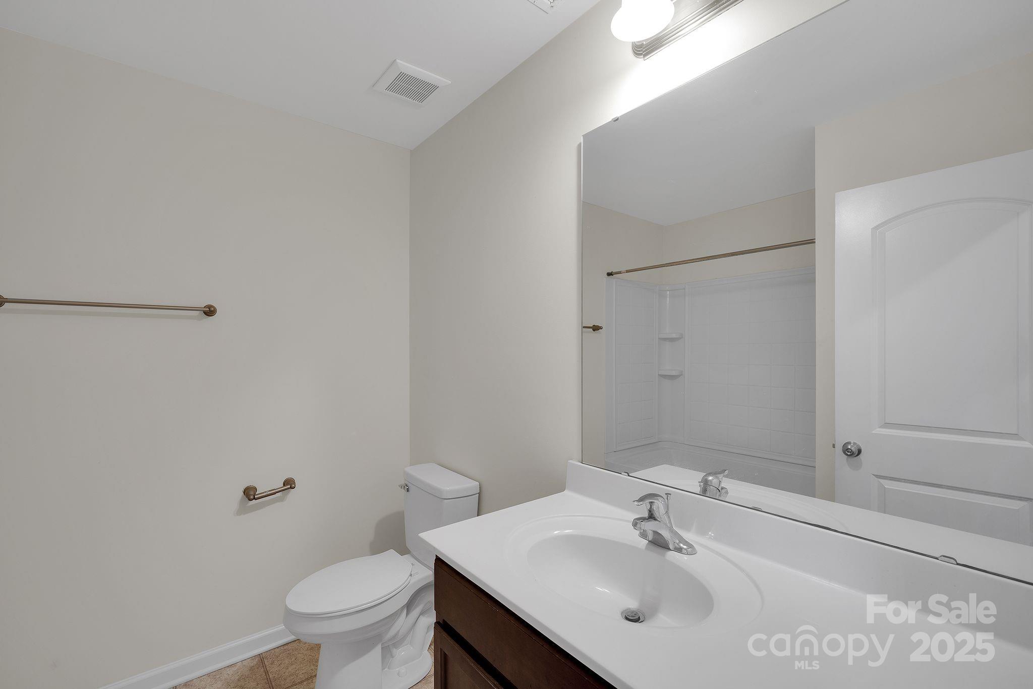 6439 Prosperity Church Road Charlotte, NC 28269 - Photo 11 of 46 a bathroom with a sink toilet and vanity