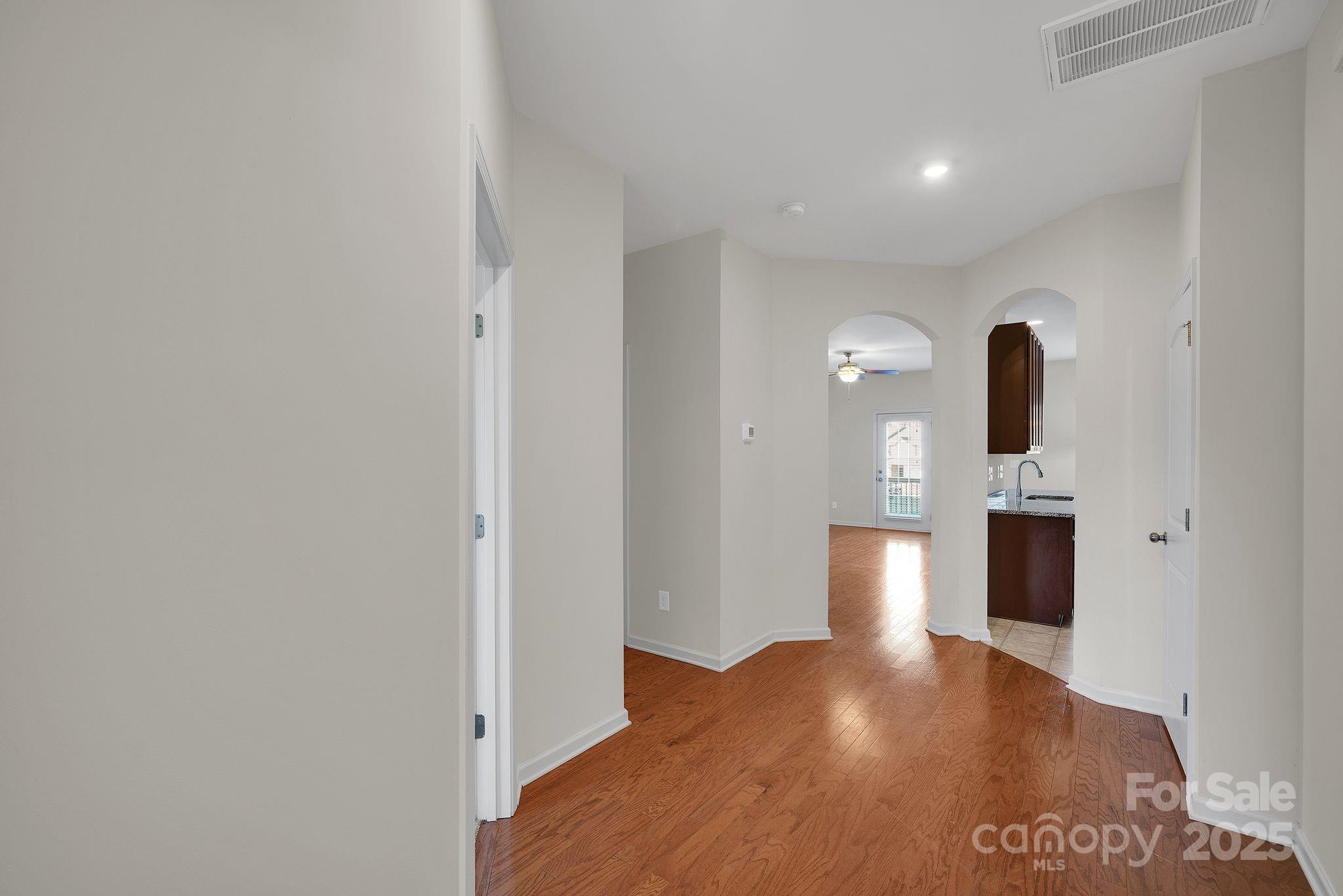 6439 Prosperity Church Road Charlotte, NC 28269 - Photo 15 of 46 a view of a hallway with wooden floor and staircase
