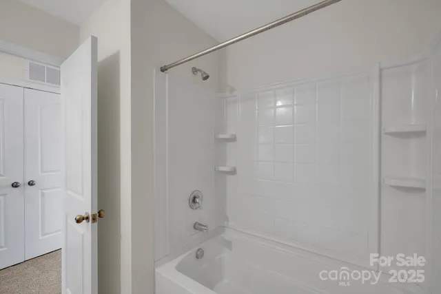 a bathroom with a shower and a tub