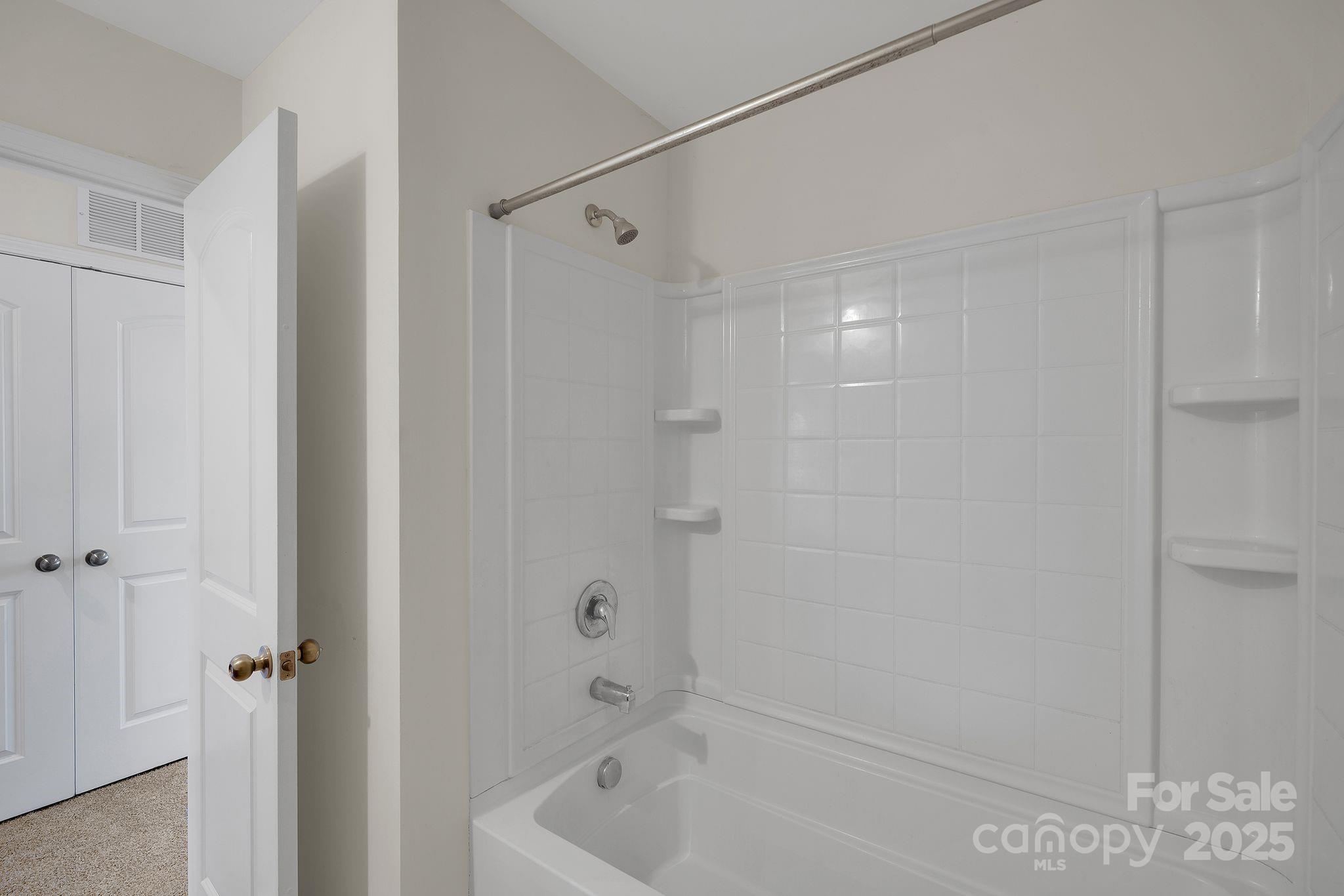 6439 Prosperity Church Road Charlotte, NC 28269 - Photo 16 of 46 a bathroom with a shower and a tub