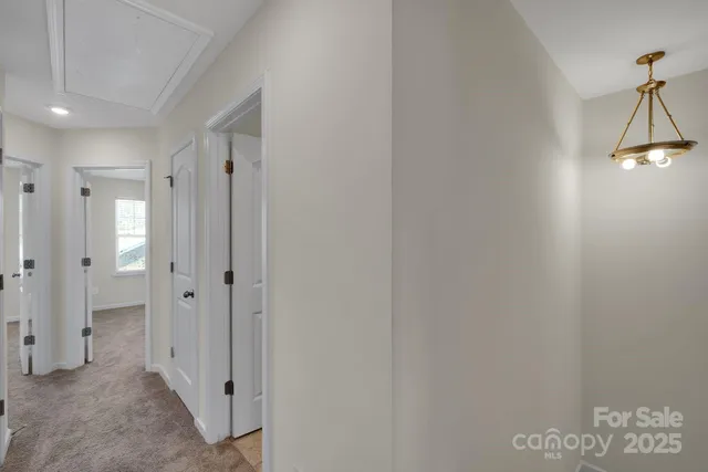 a view of a hallway with a chandelier