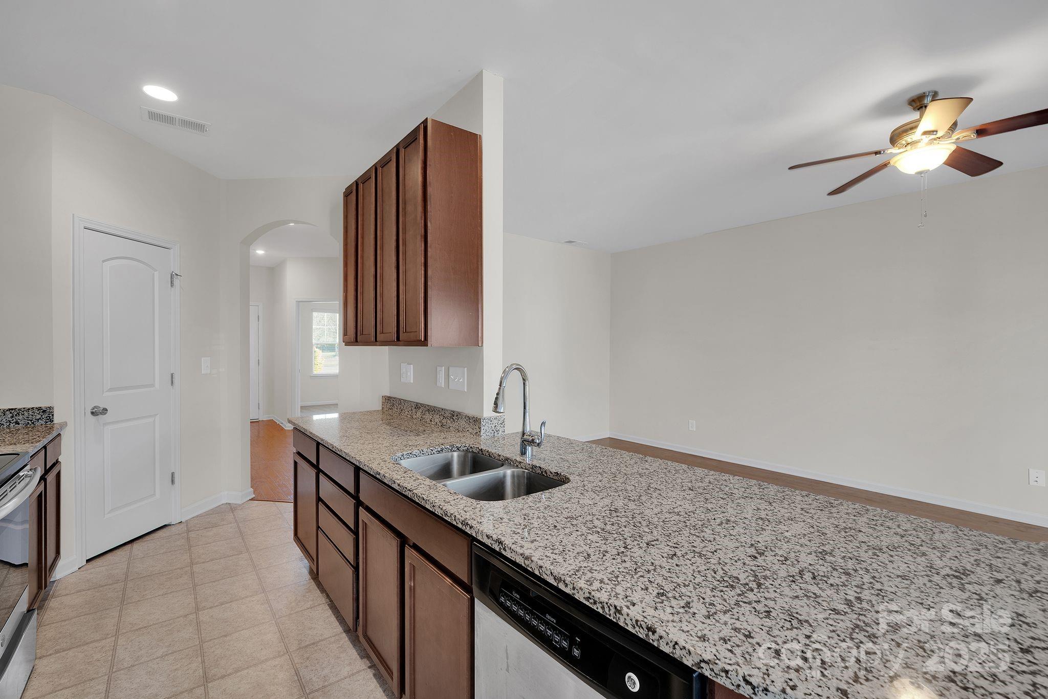 6439 Prosperity Church Road Charlotte, NC 28269 - Photo 32 of 46 a kitchen with stainless steel appliances granite countertop a sink dishwasher and refrigerator