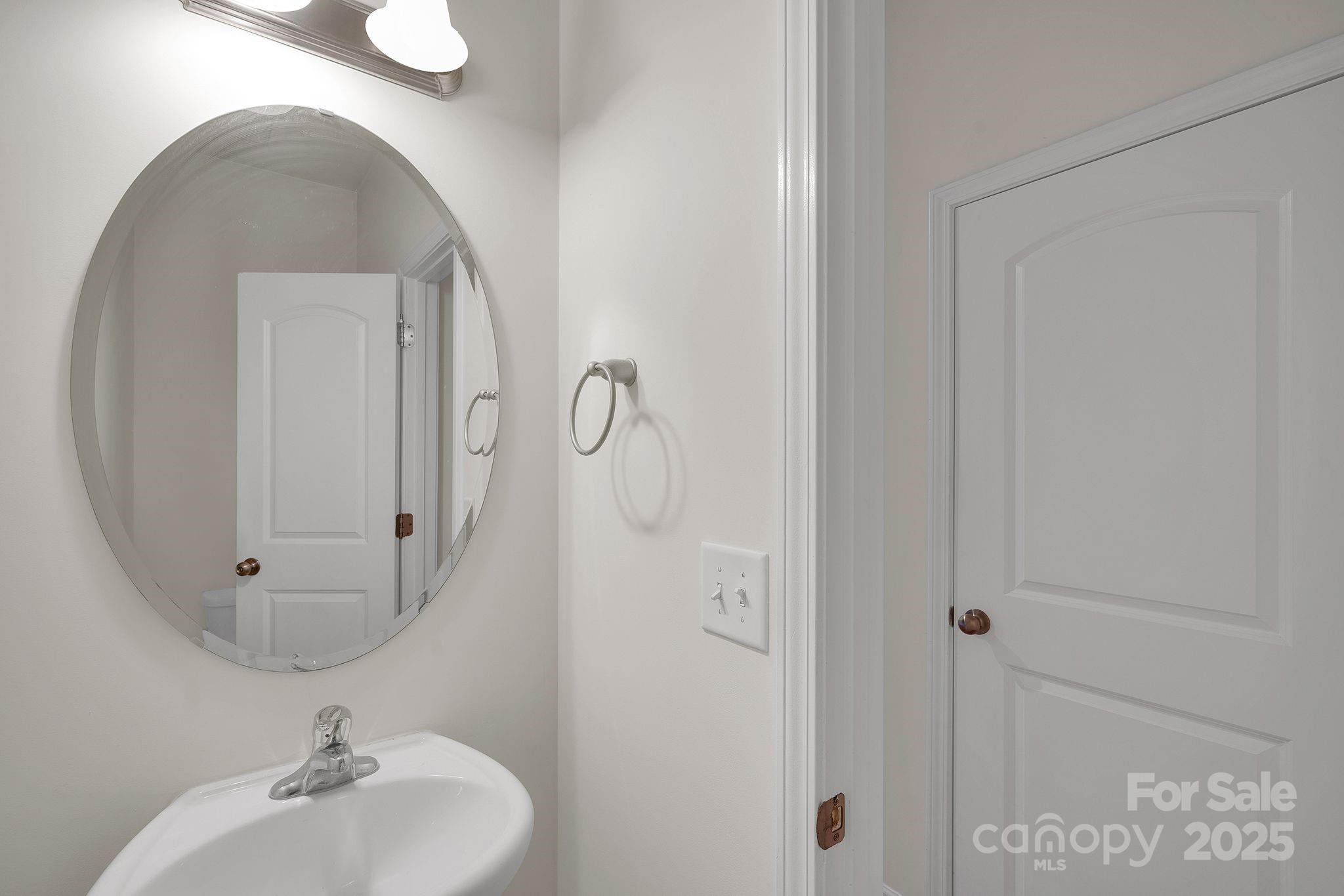 6439 Prosperity Church Road Charlotte, NC 28269 - Photo 38 of 46 a bathroom with a sink and mirror