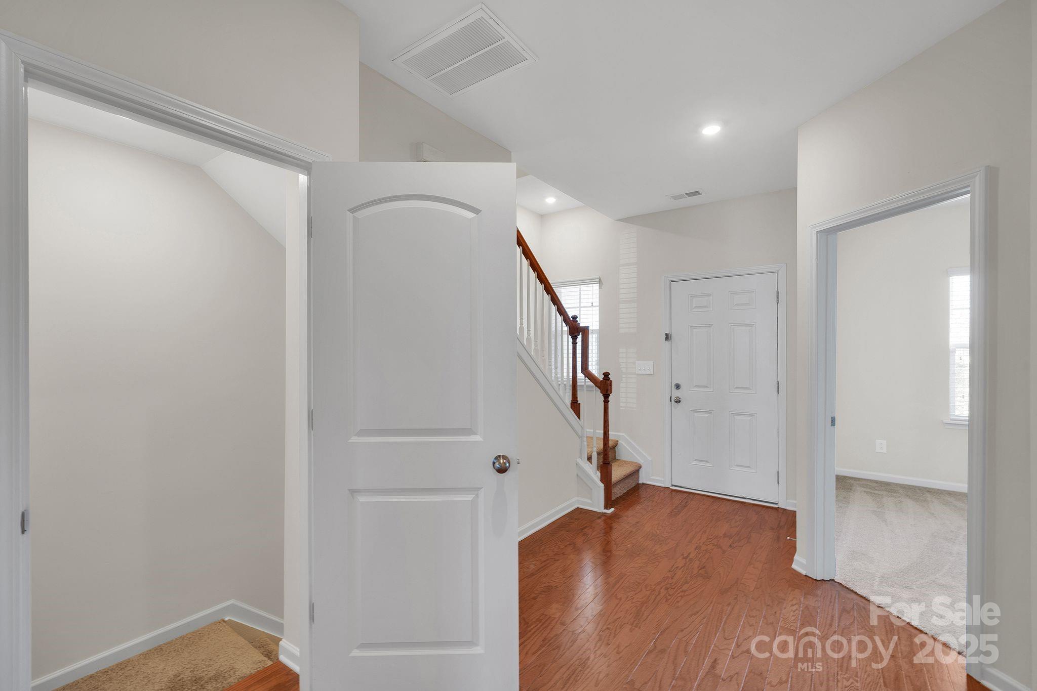 6439 Prosperity Church Road Charlotte, NC 28269 - Photo 6 of 46 a view of hallway with stairs and wooden floor