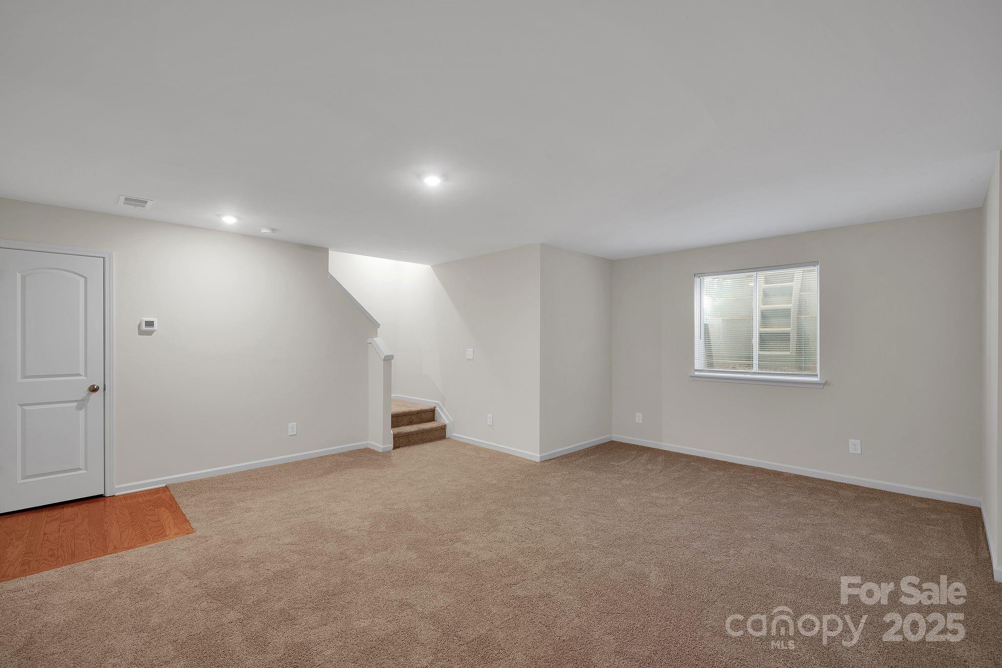 6439 Prosperity Church Road Charlotte, NC 28269 - Photo 7 of 46 a view of an empty room with a window