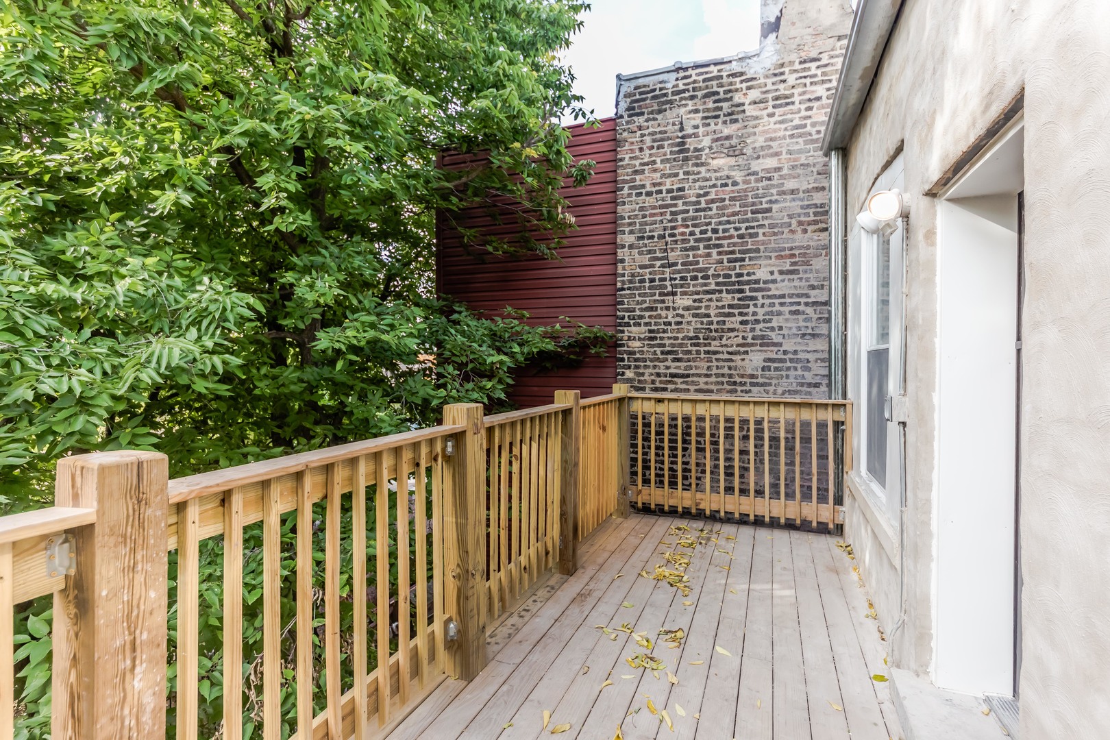 352 North Avers Avenue Chicago, IL 60624 - Photo 16 of 18 a view of wooden balcony with trees