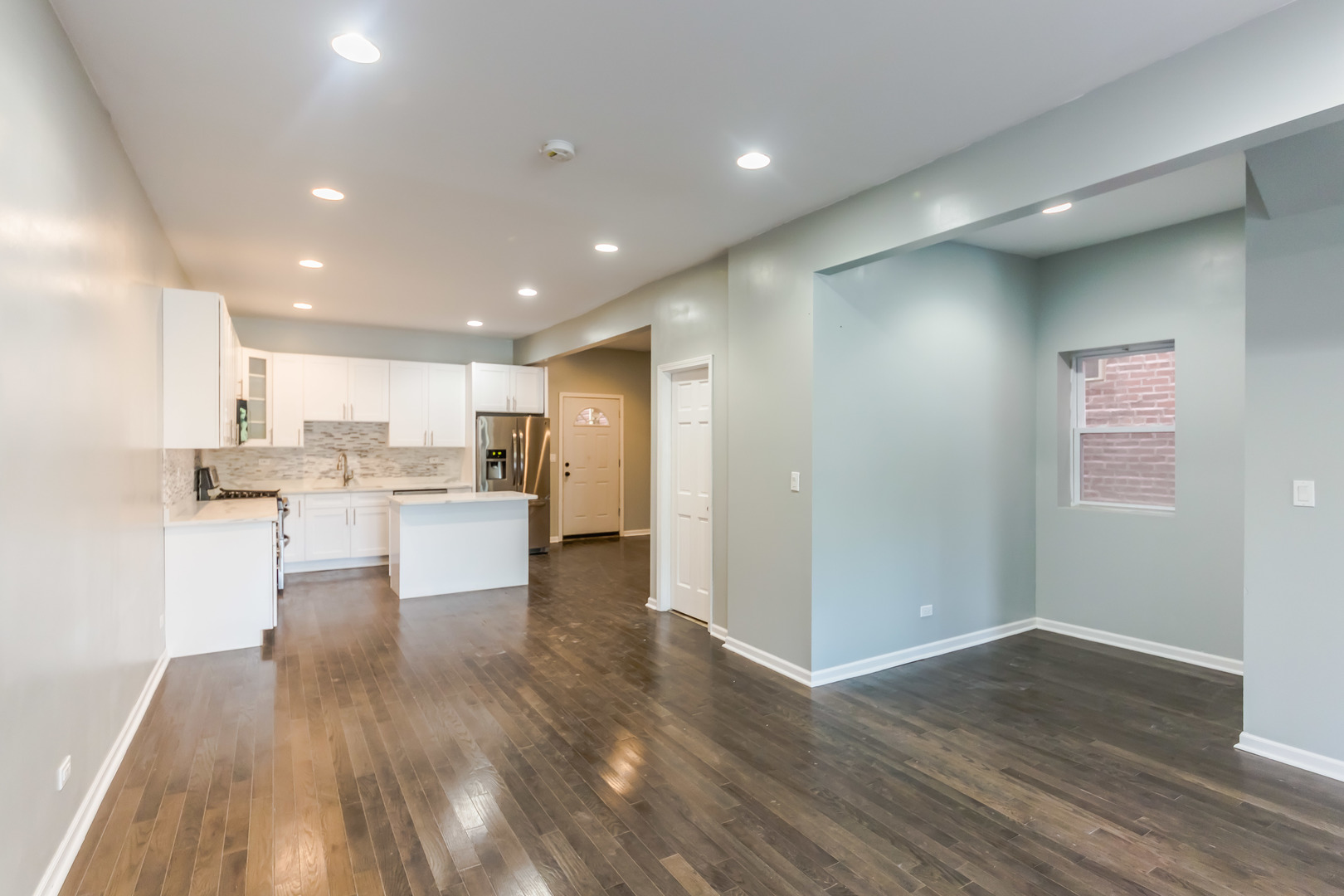 352 North Avers Avenue Chicago, IL 60624 - Photo 3 of 18 a view of kitchen dining table chairs microwave and cabinets