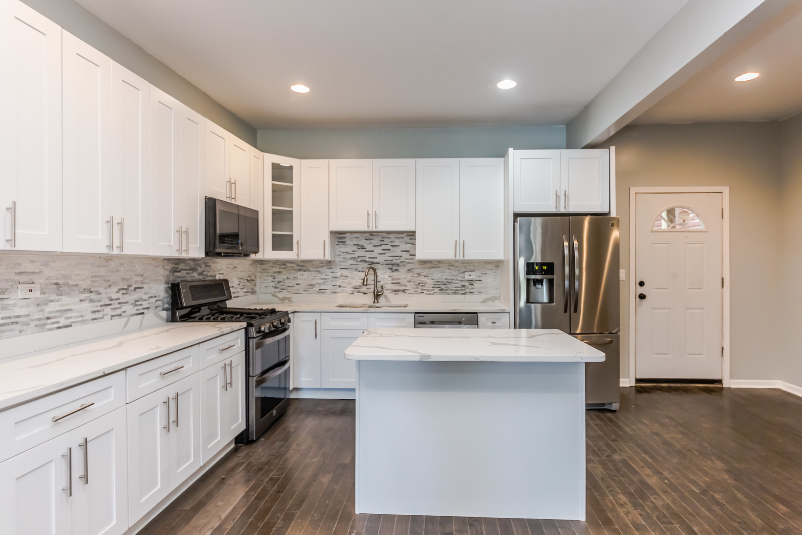 352 North Avers Avenue Chicago, IL 60624 - Photo 6 of 18 a large kitchen with stainless steel appliances a sink stove refrigerator and cabinets