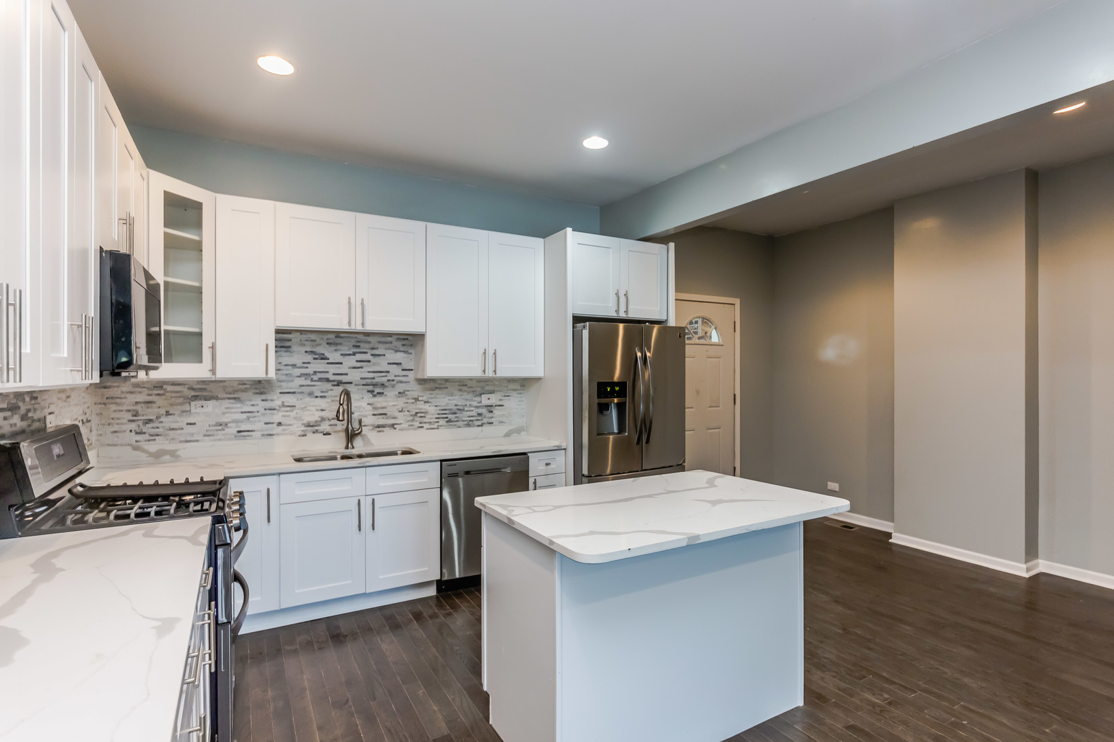 352 North Avers Avenue Chicago, IL 60624 - Photo 8 of 18 a kitchen with stainless steel appliances a sink cabinets and wooden floor