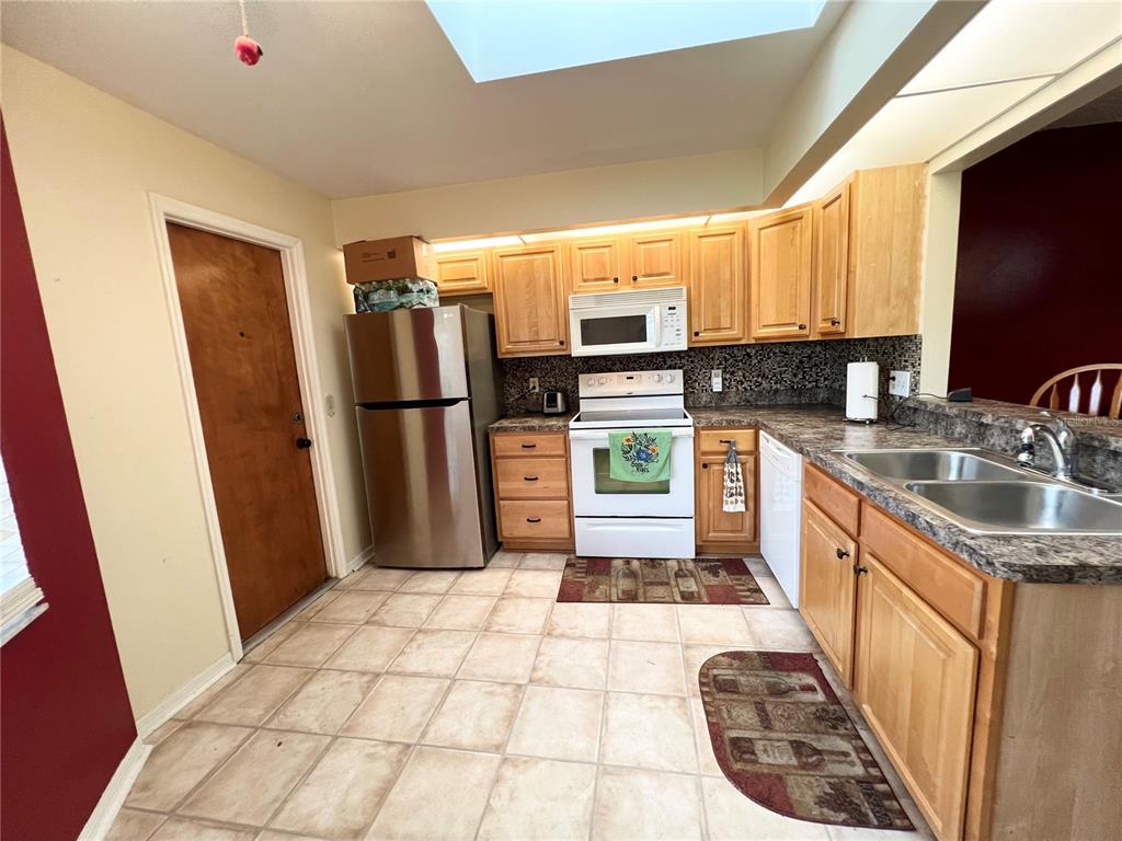 2918 West Campbell Road Lakeland, FL 33810 - Photo 6 of 10 a kitchen with stainless steel appliances granite countertop a refrigerator stove and sink