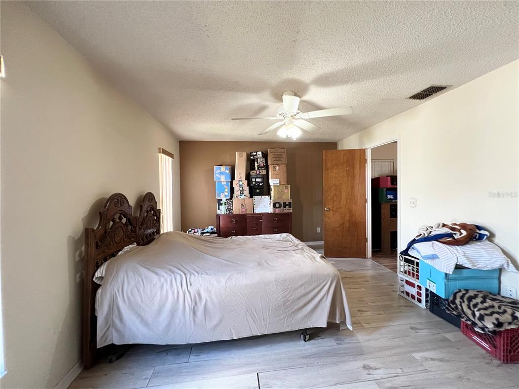 2918 West Campbell Road Lakeland, FL 33810 - Photo 7 of 10 a bedroom with a bed and wooden floor