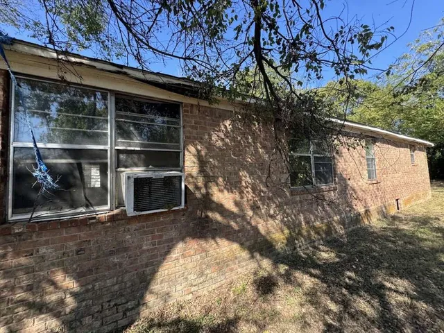 a view of a wooden door and a yard