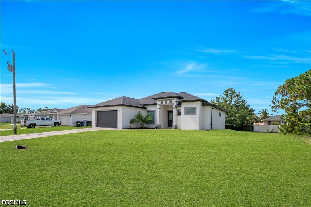 3509 38th Street Southwest Lehigh Acres, FL 33976 - Photo 6 of 47 a view of a house with a big yard