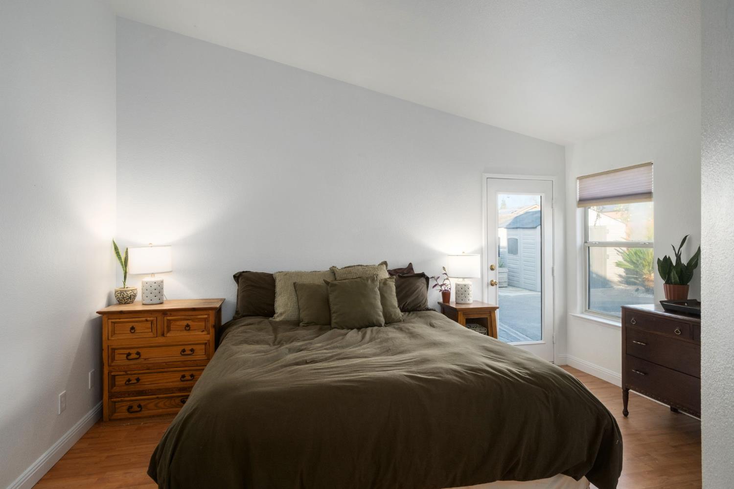 372 Lily Avenue Sanger, CA 93657 - Photo 14 of 30 a bedroom with a bed and wooden floor