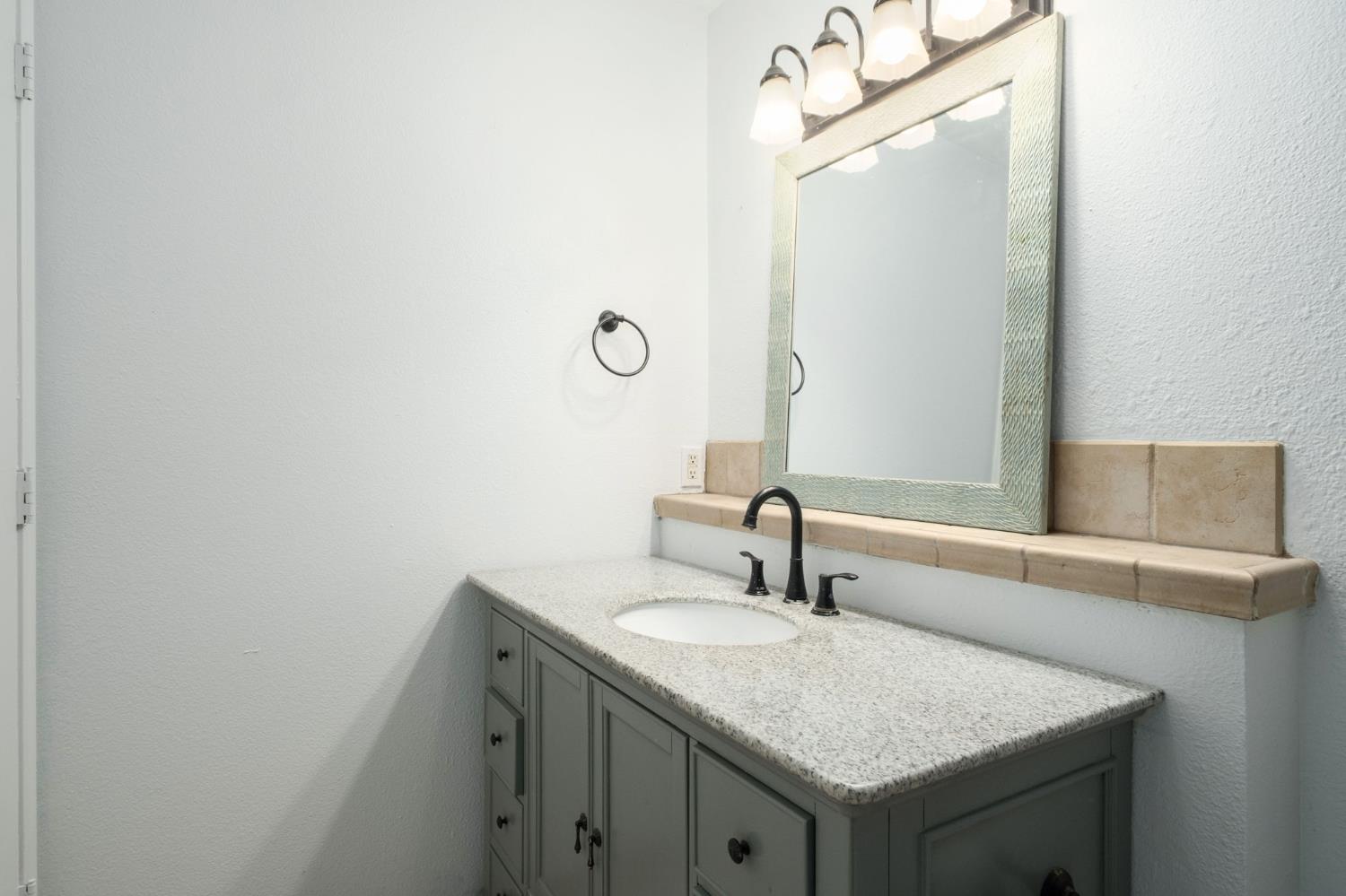 372 Lily Avenue Sanger, CA 93657 - Photo 18 of 30 a bathroom with a sink and a mirror