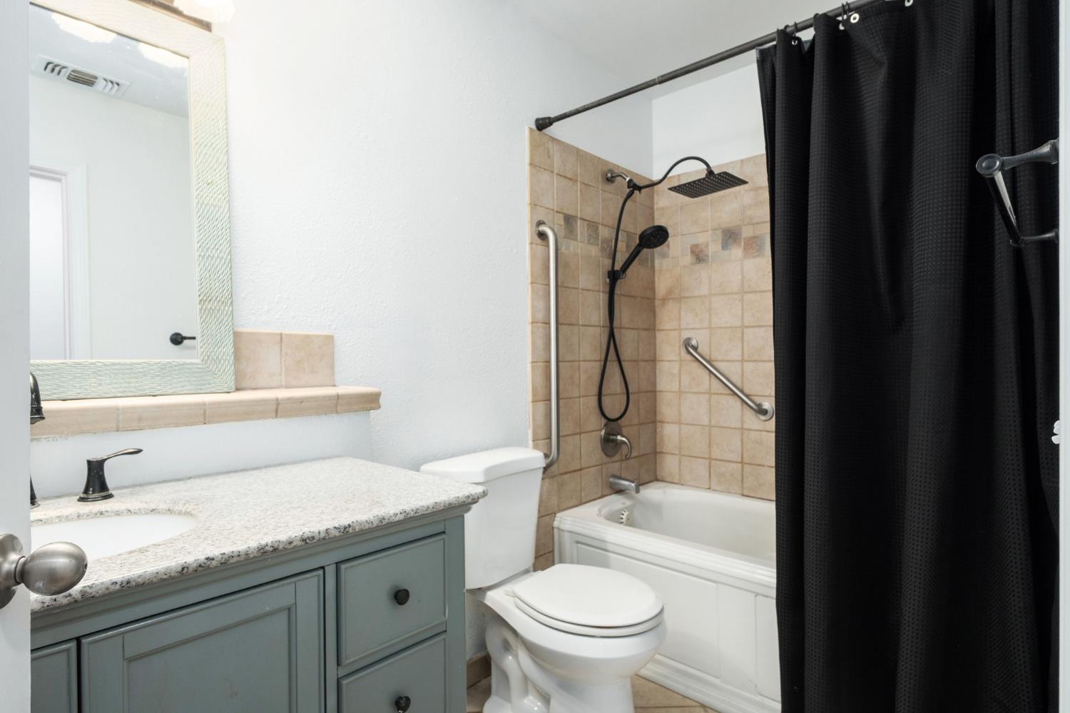 372 Lily Avenue Sanger, CA 93657 - Photo 19 of 30 a bathroom with a granite countertop sink toilet and shower
