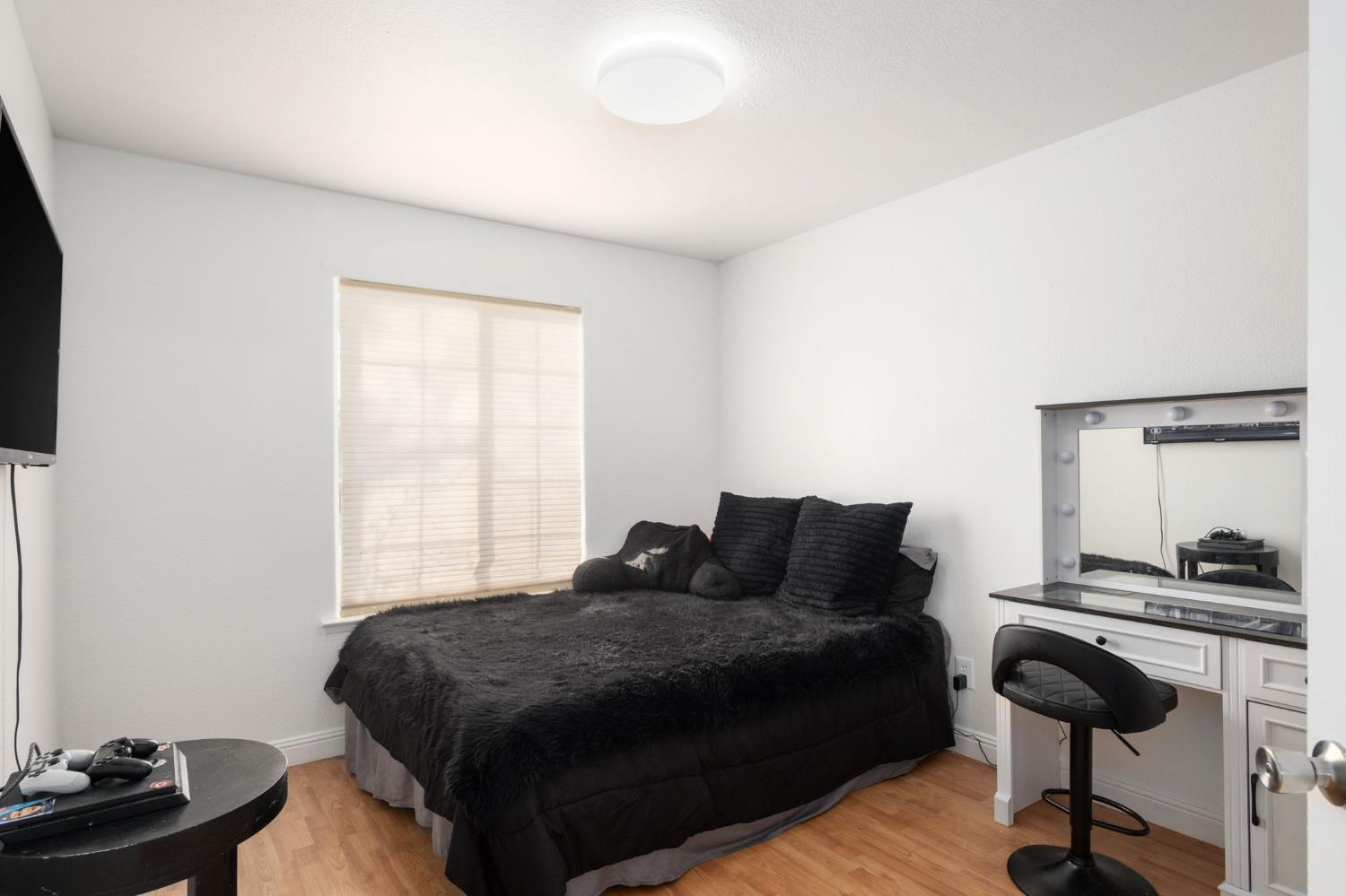 372 Lily Avenue Sanger, CA 93657 - Photo 21 of 30 a bedroom with a bed and a potted plant