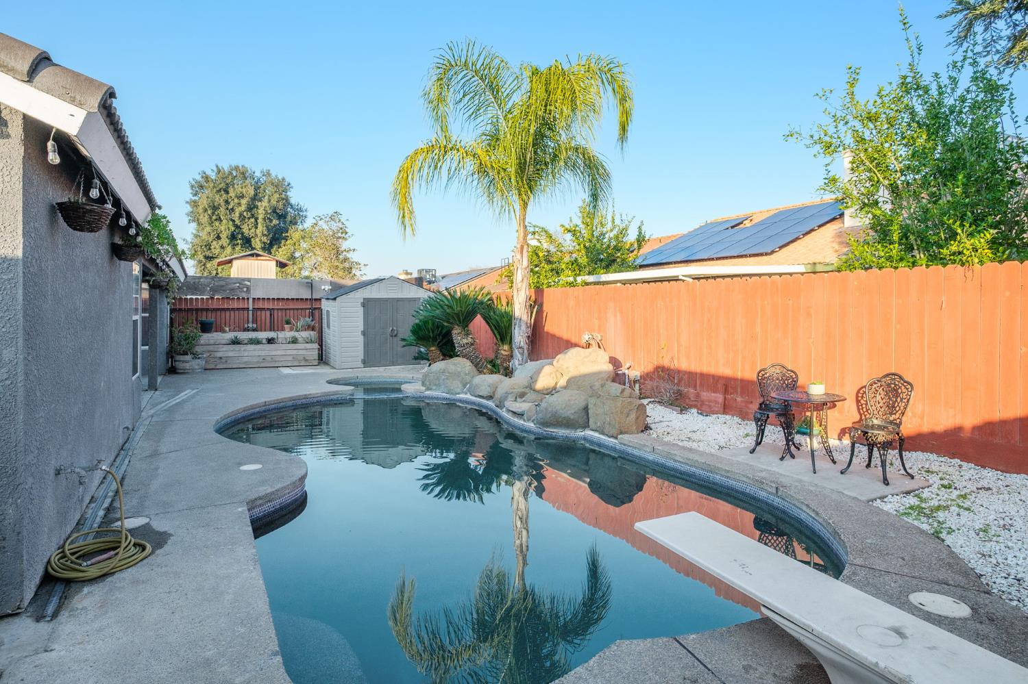 372 Lily Avenue Sanger, CA 93657 - Photo 25 of 30 a view of a swimming pool with a lounge chairs