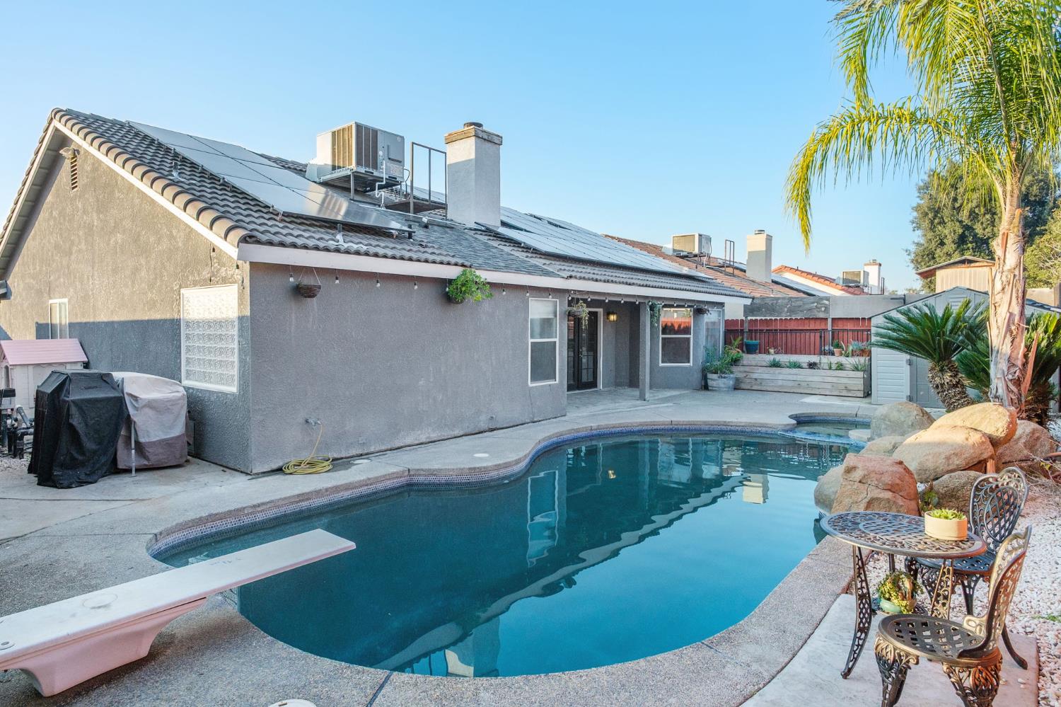 372 Lily Avenue Sanger, CA 93657 - Photo 26 of 30 a view of a house with pool and chairs