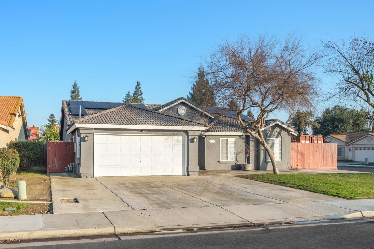 372 Lily Avenue Sanger, CA 93657 - Photo 29 of 30 a front view of a house with a yard and garage