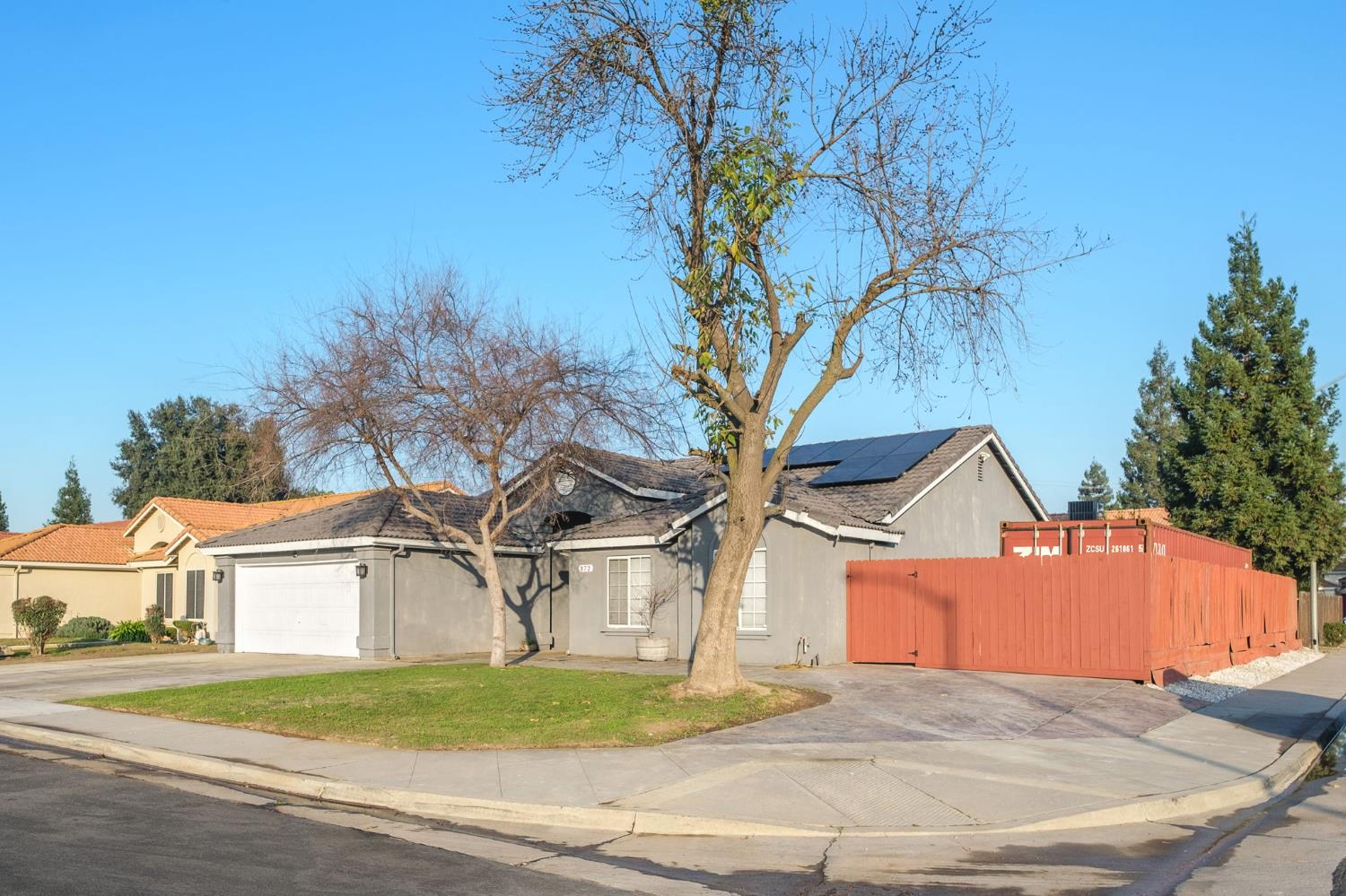 372 Lily Avenue Sanger, CA 93657 - Photo 30 of 30 a front view of a house with a yard and garage