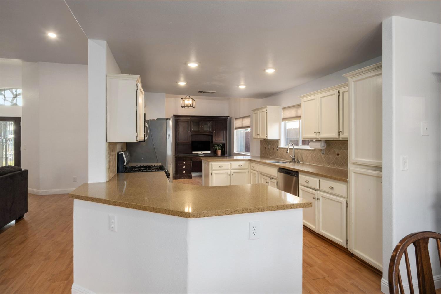 372 Lily Avenue Sanger, CA 93657 - Photo 9 of 30 a kitchen with stainless steel appliances granite countertop a sink a stove and a refrigerator