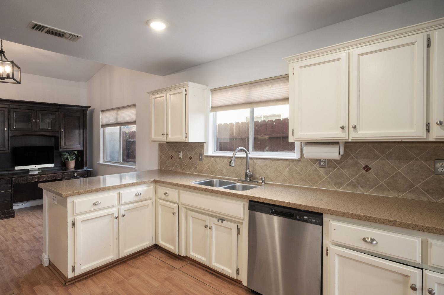 372 Lily Avenue Sanger, CA 93657 - Photo 10 of 30 a kitchen with a sink stove and cabinets