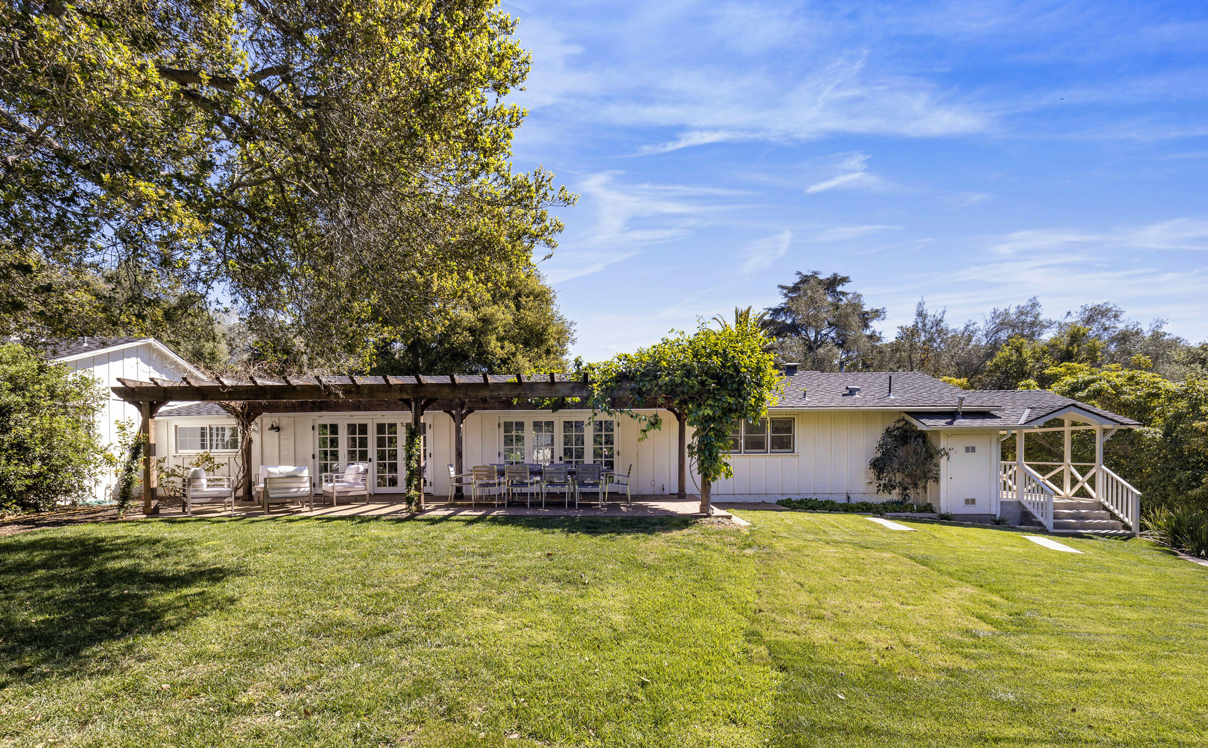 645-675 Olive Road Montecito, CA 93108 - Photo 33 of 34 a house view with swimming pool and trees in the background