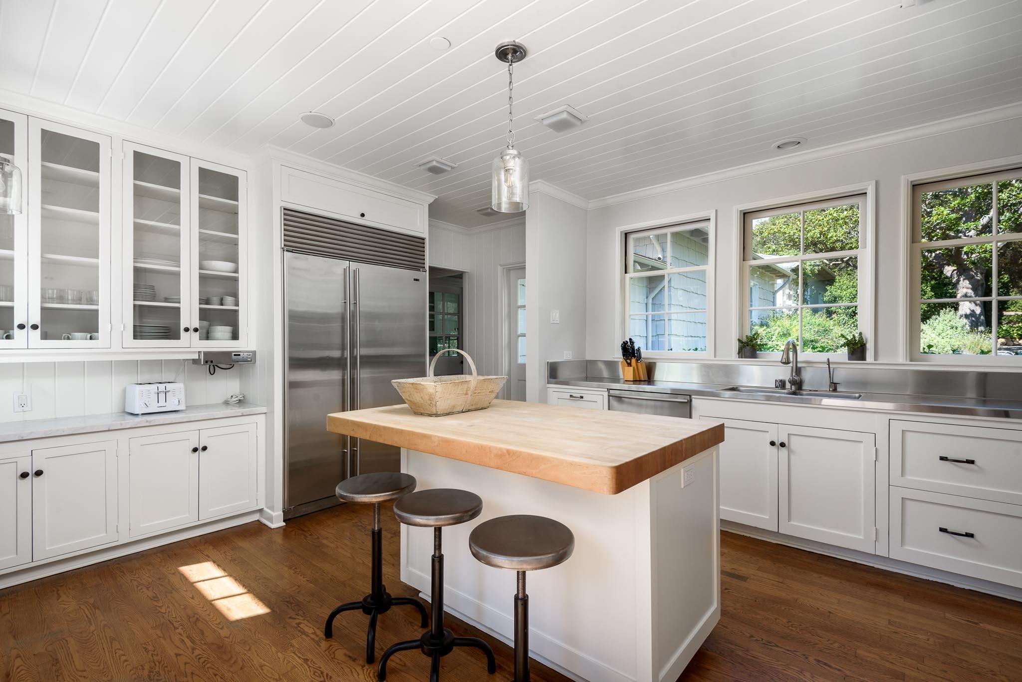 645-675 Olive Road Montecito, CA 93108 - Photo 8 of 34 a kitchen with sink a center island and cabinets