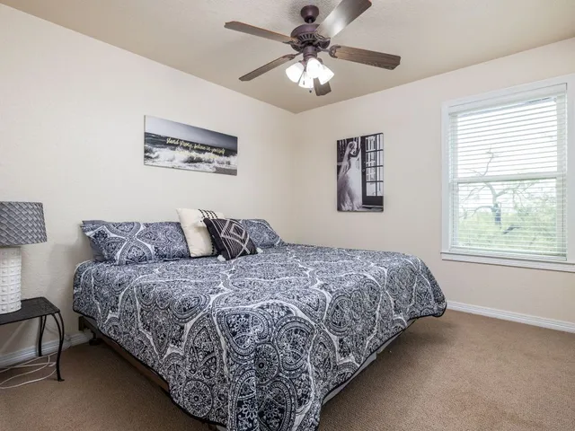 a bed sitting in a bedroom next to a window