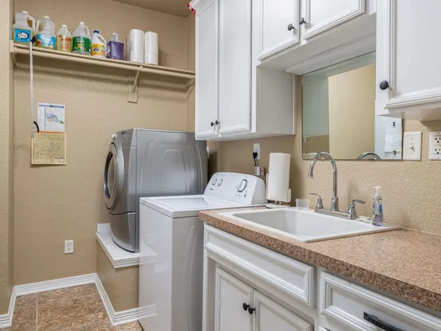a utility room with a sink washer and dryer
