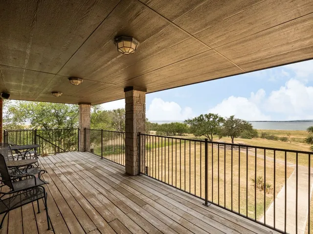 a view of a balcony with lake view and wooden floor