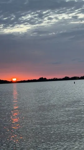 a sunset view with a lake